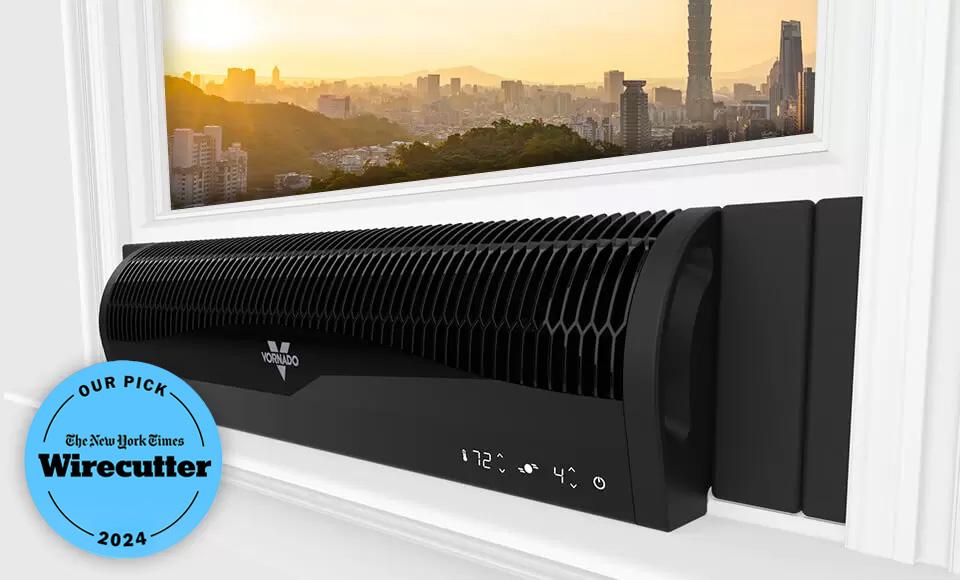 Wirecutter Transom Award 2024 Vornado Transom Window Fan in a window with a city scape shown in the glass pane above it. There is a blue badge to the left of it that says Our Pick the New York Times Wirecutter 2024